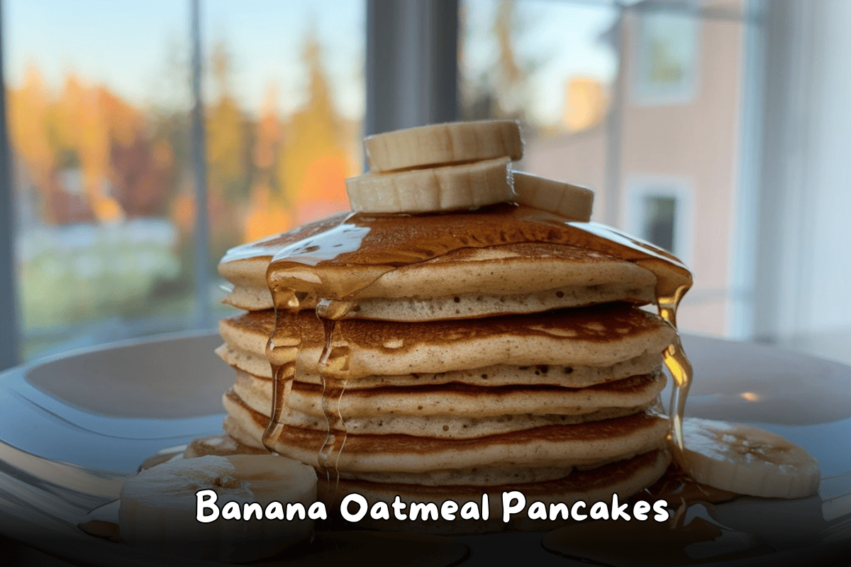 Stack of banana oatmeal pancakes topped with banana slices and drizzled with maple syrup.